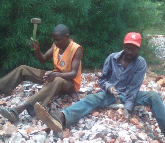Charles Ouma, needy university student working fingers to the bone to raise fees Charles Ouma, a Moi University student (left) in orange jacket and his dad (John Origi) in red cap, crushing concrete at a quarry site in Budalangi, Busia County, to raise money for fees. Despite the efforts, he has been unable to get the fees and appeals to people of goodwill to chip in and help him out. PHOTO/Gilbert Ochieng, The Scholar Media Africa.
