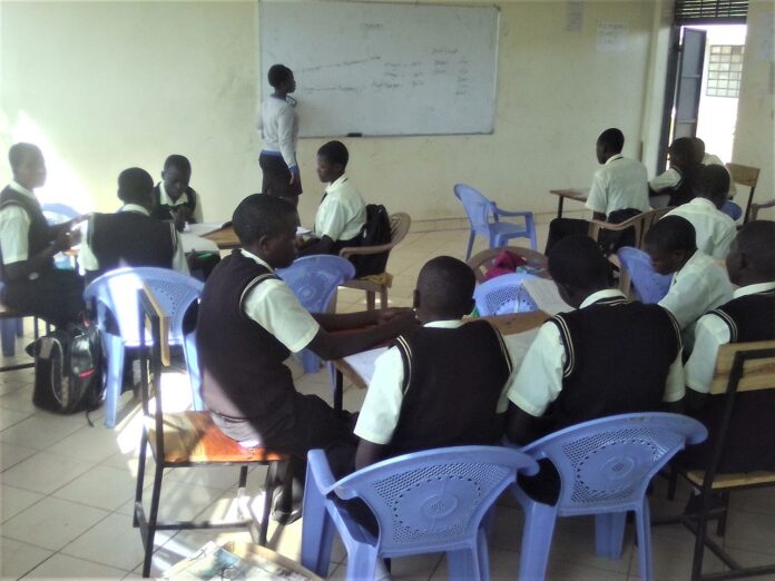 A teacher at Peter Habenga Okondo secondary School in Budalangi, Busia County talking the students through a lesson. PHOTO/Gilbert Ochieng, The Scholar Media Africa.