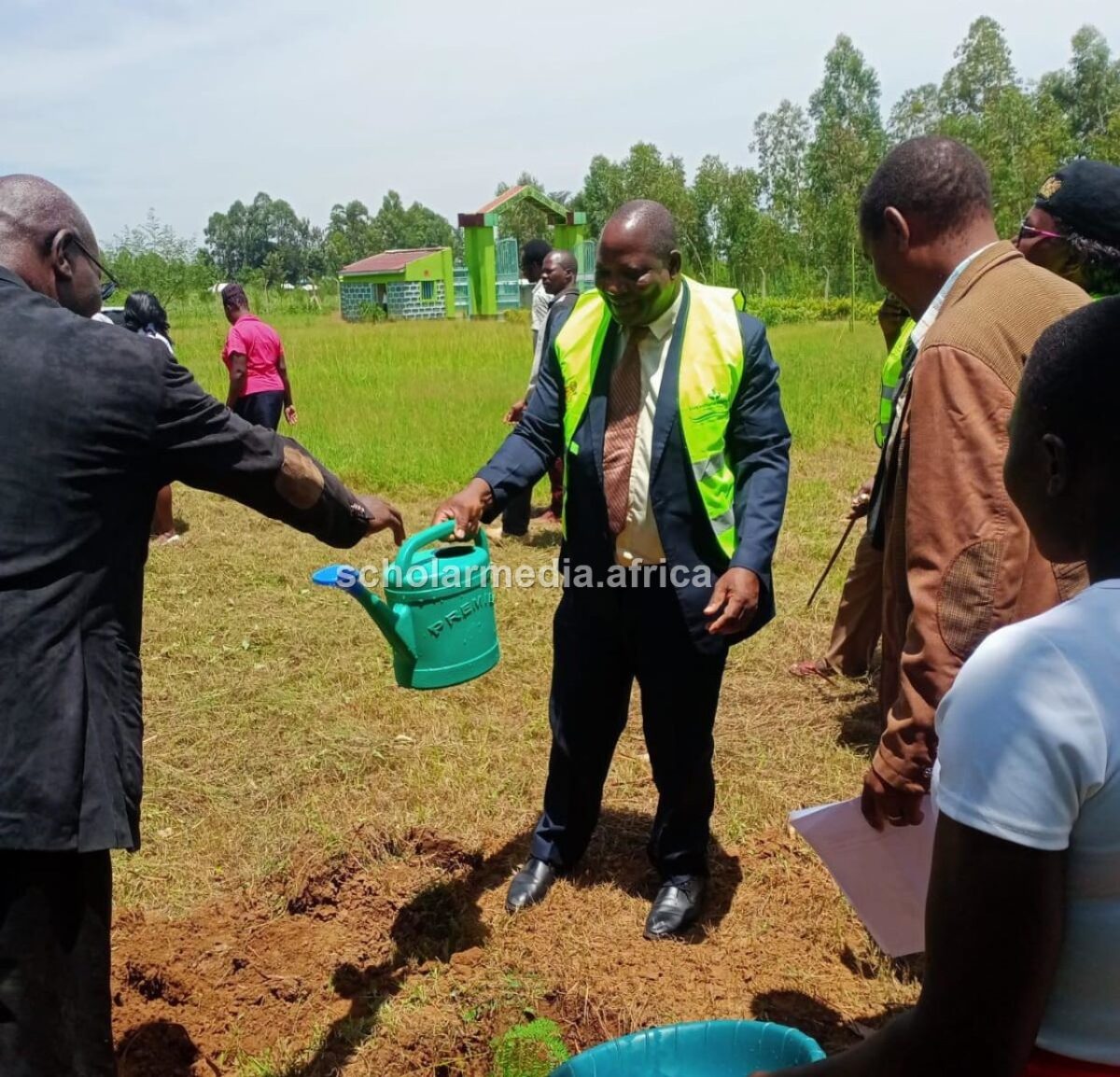 Taskforce chairman for Agriculture, Water, Trade, Lands and Municipality, Patrick Odame, watering a tree seedling during a recent tree planting exercise in Busia County. PHOTO/Gilbert Ochieng, The Scholar Media Africa.