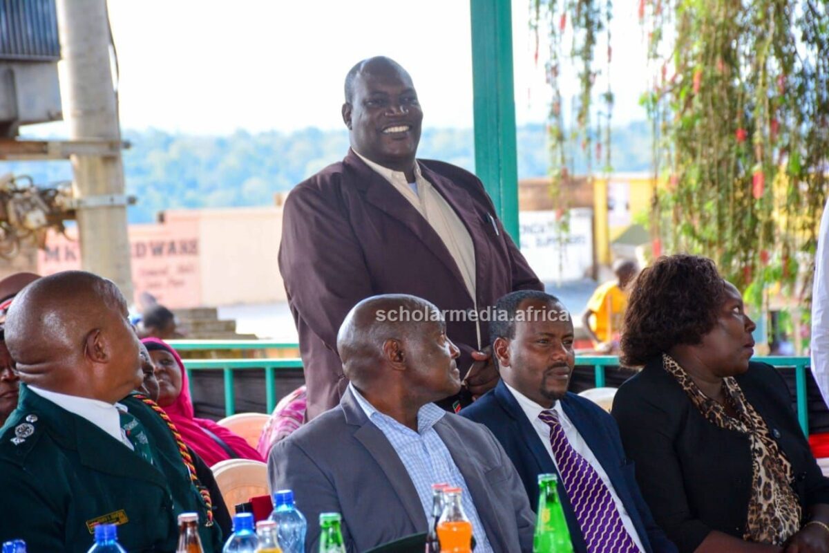Koibatek Sub-County Director of Education Simeon Kemei being introduced by the Deputy County Commissioner Omari Ali at the Mashujaa Day celebrations. PHOTO/Janet Kiriswo, The Scholar Media Africa.