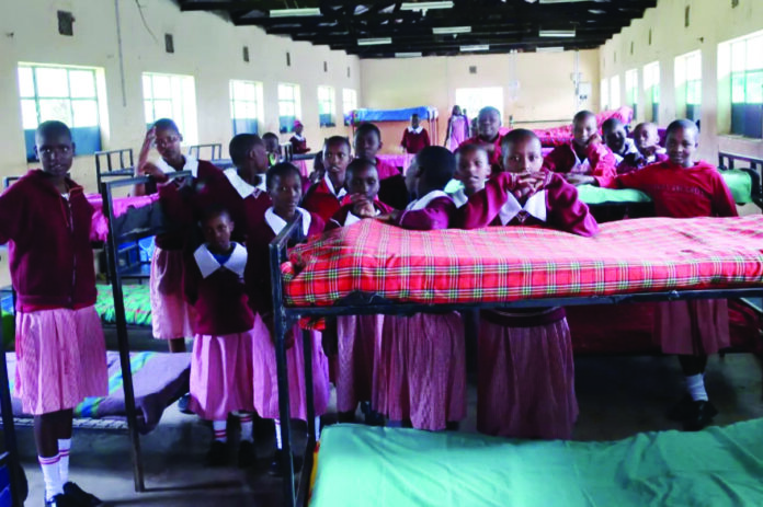Girls in a dormitory at Naikarra Primary School in Narok. Pupils can board at the school or attend as day-scholars. The Education Ministry, through the Basic Education PS Dr. Belio Kipsang, announced plans to abolish the boarding section in primary schools starting January next year. PHOTO/Courtesy.