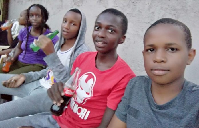 Michael Kariuki, second from right, with other students, listen to an address by the school leadership at the school grounds shortly after the release of the 2022 KCPE results. The school performed excellently. PHOTO/Njoroge Njuguna, The Scholar Media Africa.