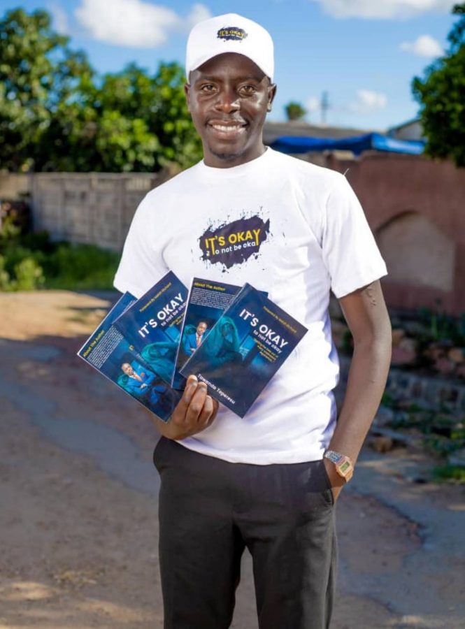 Tawanda Toperesu, the book author, holding copies of his work. PHOTO/Courtesy.
