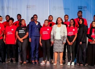 CRIME: Community Paralegals graduate ready to abate crime, step up justice Elizabeth Marube of National Police Service (in blue) and Zainab Abdul, a Principal Magistrate, pose for a photo with graduands during a community paralegals graduation at Sarakasi Dome, Nairobi, courtesy of Sheria Mashinani Initiative. PHOTO/Crime Si Poa (CSP).