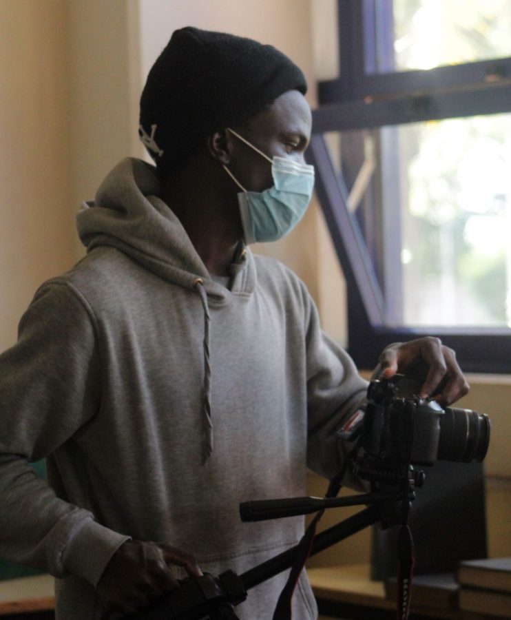 Ryann Okello, a student of Film Studies at Moi University, creative writer and cinematographer, shooting a film. PHOTO/Courtesy.