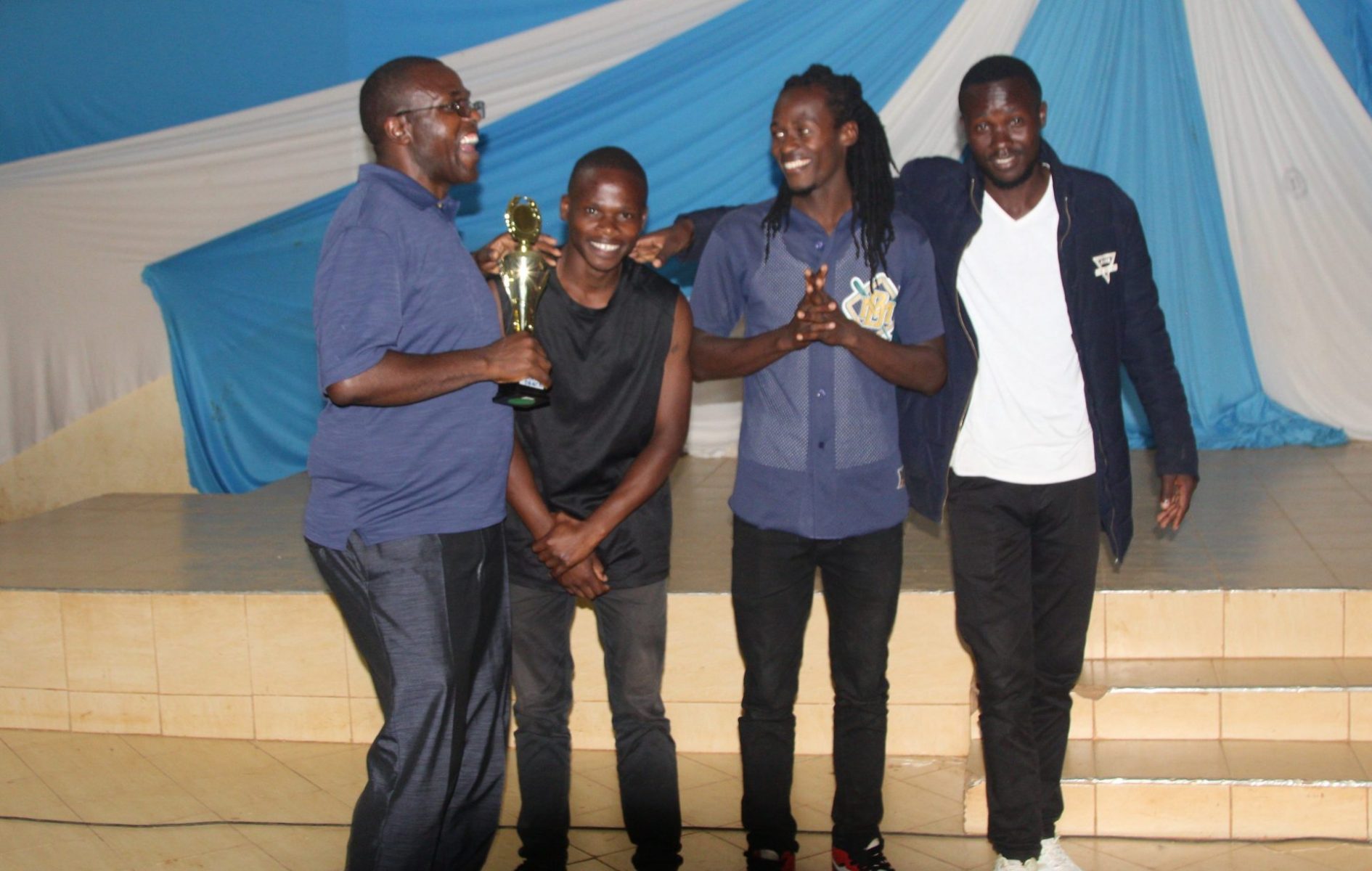 Dr. George Aberi, the Department Chair of Languages, Linguistics and Literature, gifting the Elites group for bagging position one in Modern Dance. PHOTO/Boaz Khuteka.