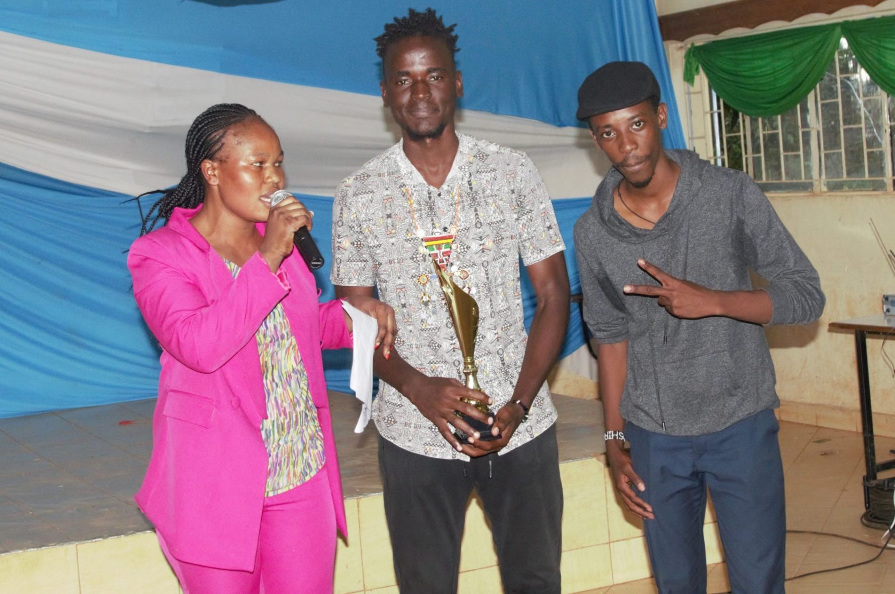 Eunice Samuel and some of the winners after getting a trophy. PHOTO/Boaz Khuteka, KAU Media.