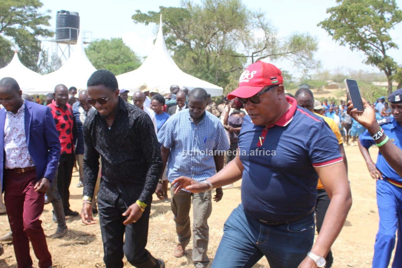 Budalangi MP Raphael Wanjala (red cap) arrives at the venue to attend the official opening of the new public library recently. PHOTO/Gilbert Ochieng, Scholar Media Africa.