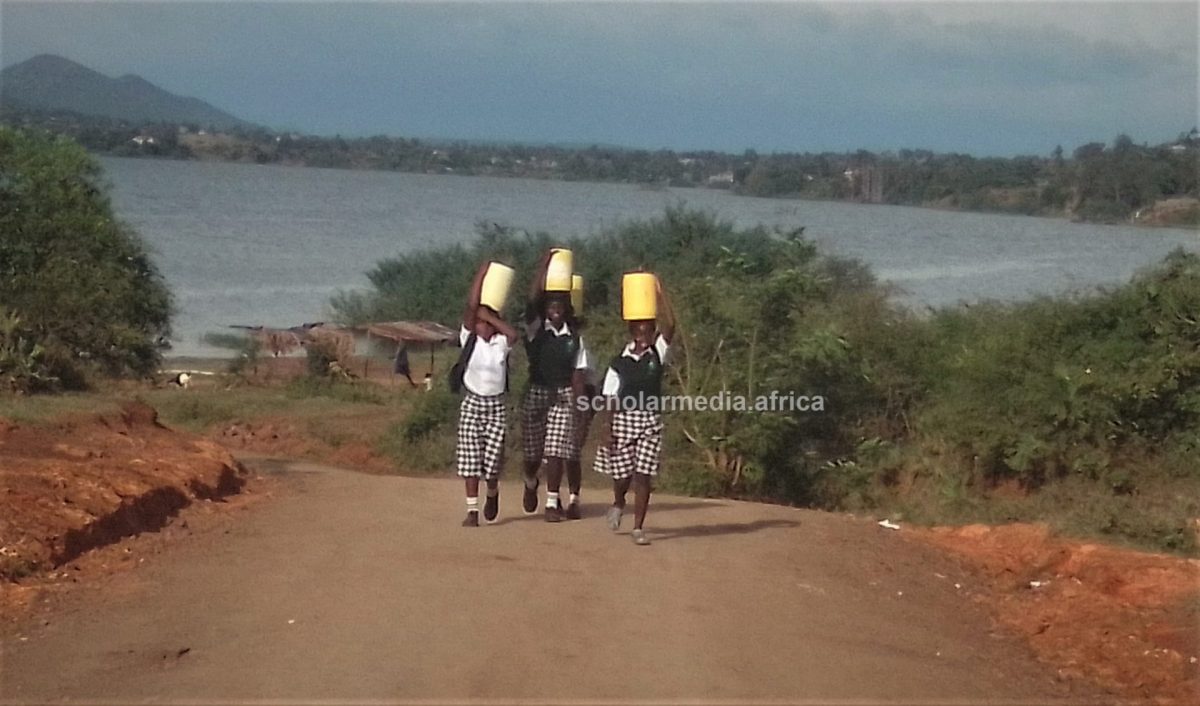 The students returning to school after fetching water. PHOTO/Gilbert Ochieng, Scholar Media Africa.