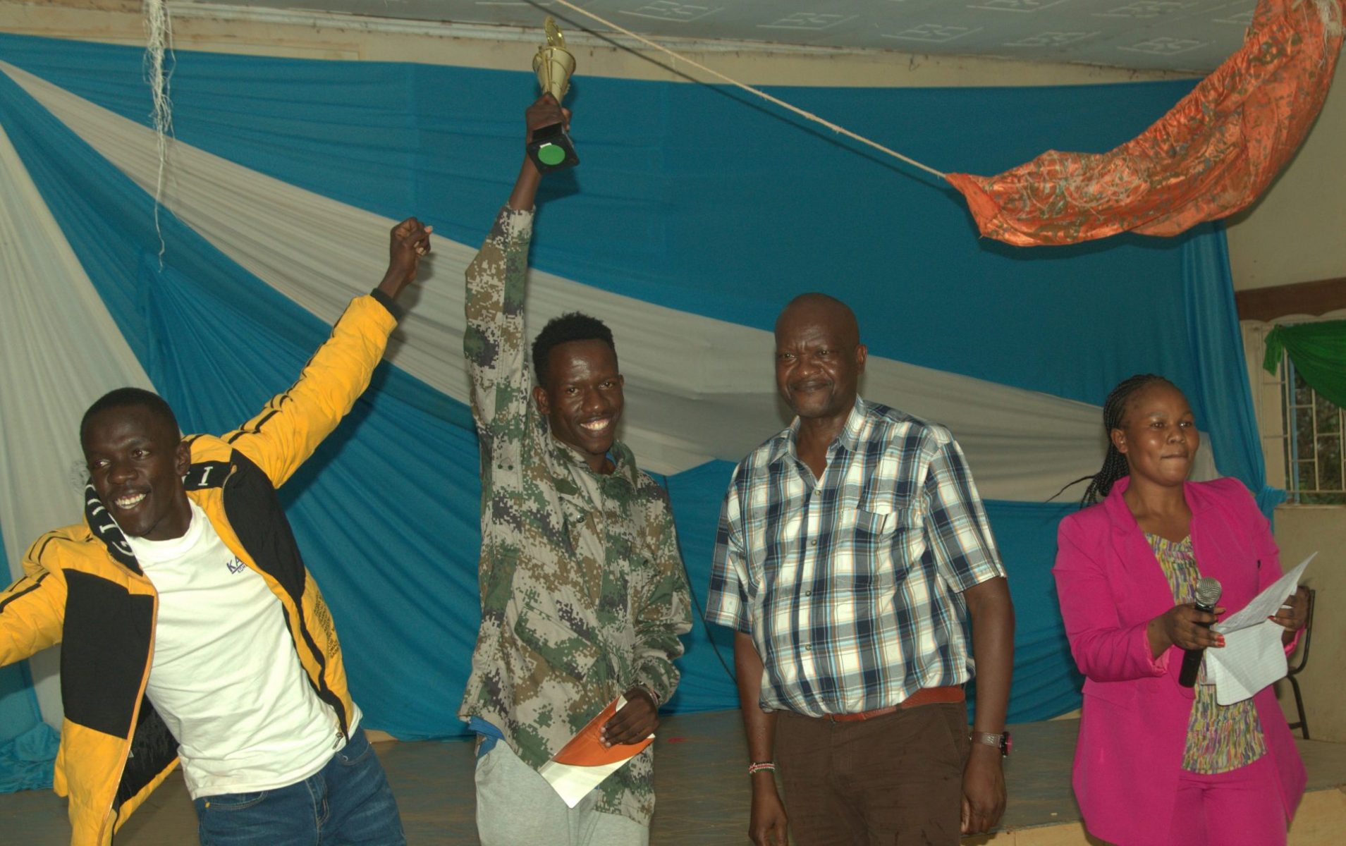 Obino Nyambane (second right) posing for a photo with the Rongo Rendo group, who won the dramatized dance. PHOTO/Boaz Khuteka, KSU Media.