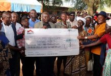 Thousands of Budalangi’s needy students to benefit from bursaries Raphael Wanjala (in orange shirt), MP Budalangi Constituency, presenting a cheque worth KSh33m for education bursary in Budalangi recently. PHOTO/ Gilbert Ochieng, Scholar Media Africa.