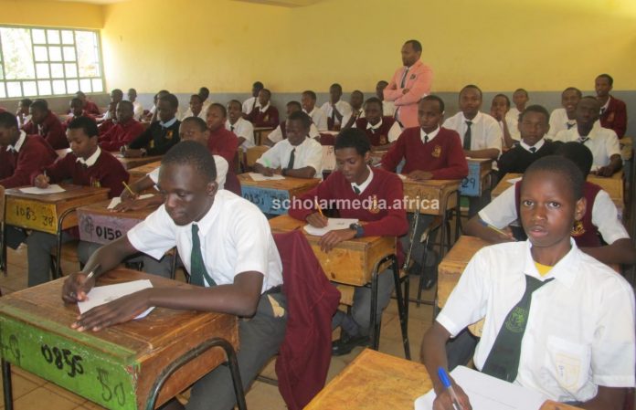 Form Two Purple students of Dagoretti High School, an extra-county school in Nairobi, doing their examinations, supervised by Mr. Moses Mutinda. PHOTO/Tebby Otieno, Scholar Media Africa.