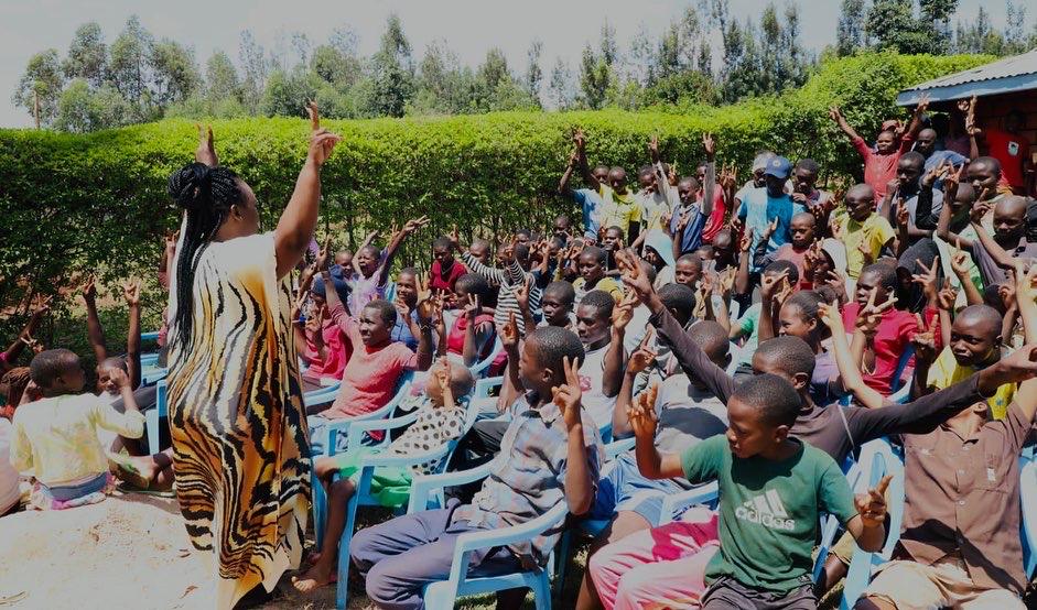Ms. Kangwana engaging adolescents on mental health related issues at the grassroots. Communities need to destigmatize mental health issues. PHOTO/Courtesy. 