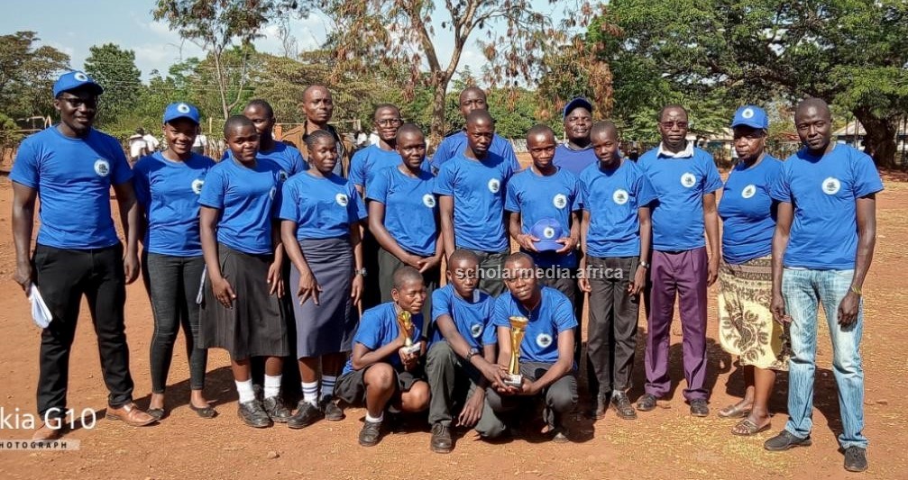 Students and patrons pose for a photo with their trophies at Ndenga Secondary after the competitions. PHOTO/Bonface Otieno, Scholar Media Africa. 