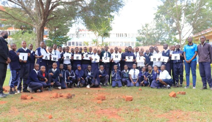 Everlyn Kimibei (second right), a staff at Kisii University, poses for a photo with learners from Kisii Primary School and some of their teachers. She's leading a group sensitizing pupils and the general public concerning waste management and environmental conservation. PHOTO/Courtesy.