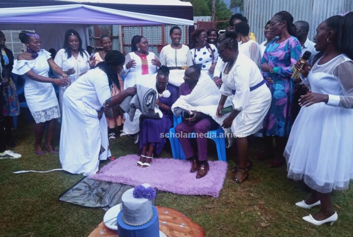 Margaret Wangeci Otieno and husband Francis Otieno (both seated) receive presents during the celebration of Wangeci's decade while thriving against breast cancer. PHOTO/Edmond Kipngeno, Scholar Media Africa.