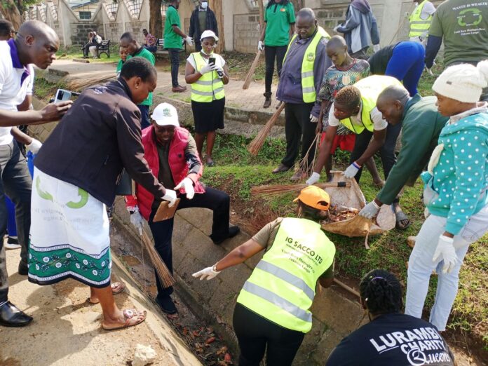 Residents of Kakamega County together with the county government officials, help clear litter and garbage from the trenches and on the pavement during a clean-up exercise on January 19, 2024. PHOTO/Joseph Otieno, Scholar Media Africa.